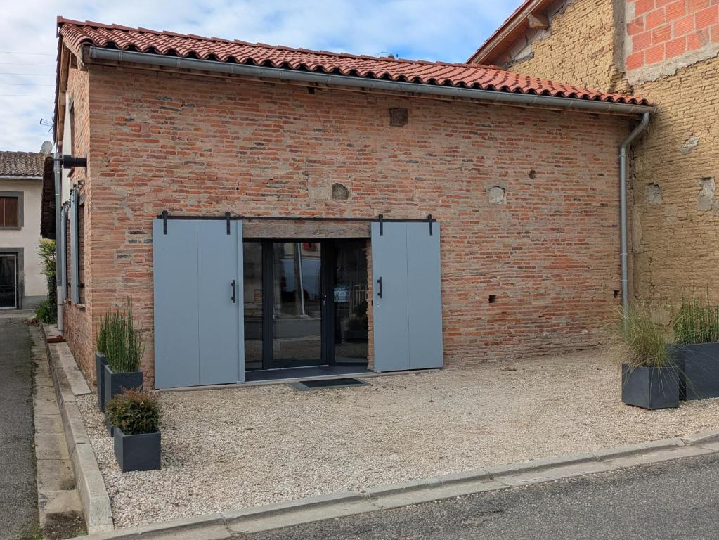 an open door of a brick building at GITE La GRANGE in Launac
