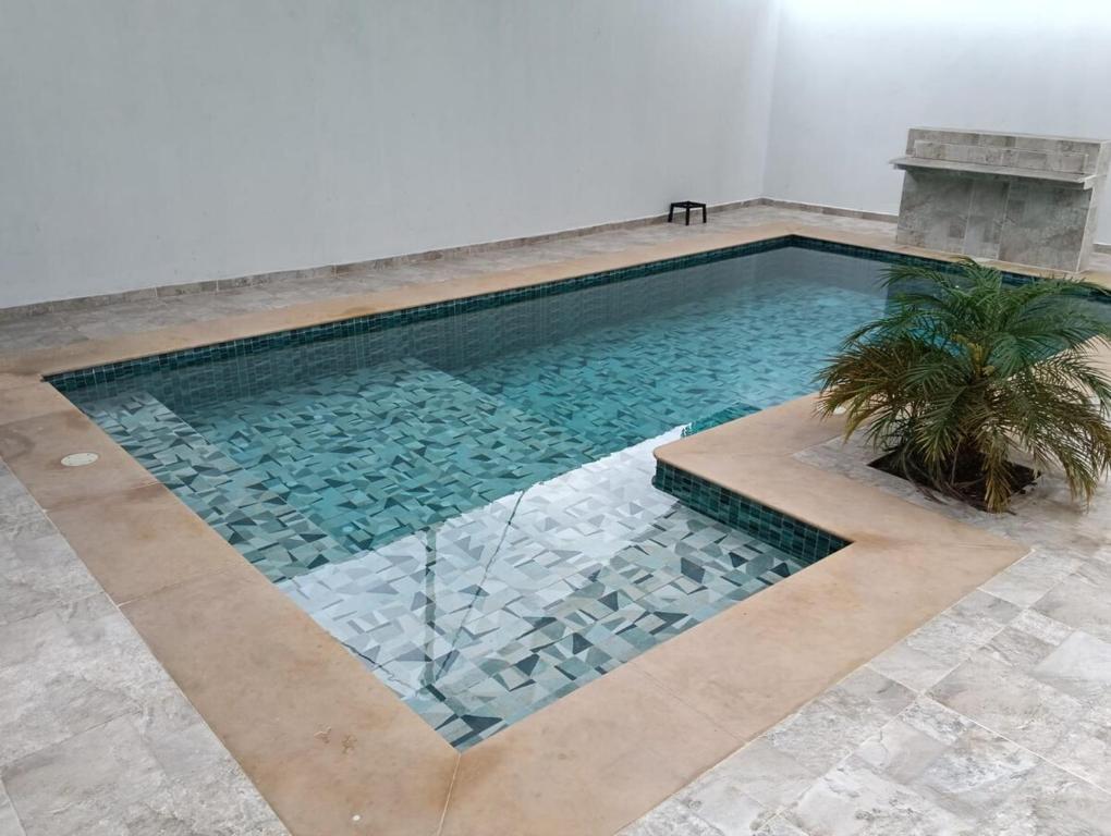 a swimming pool in a room with a tile floor at Casa familiar con piscina privada in Agua de Dios