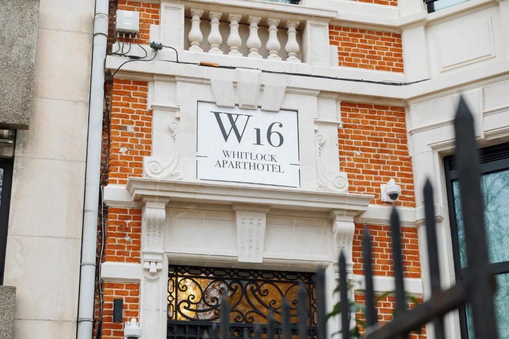 a sign on the side of a building at Whitlock16 - Luxe Aparthotel Montgomery Square Brussels in Brussels