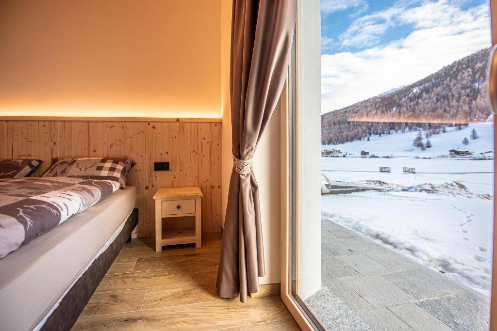 Ένα ή περισσότερα κρεβάτια σε δωμάτιο στο Alpen Chalet Colfè - Myholidaylivigno