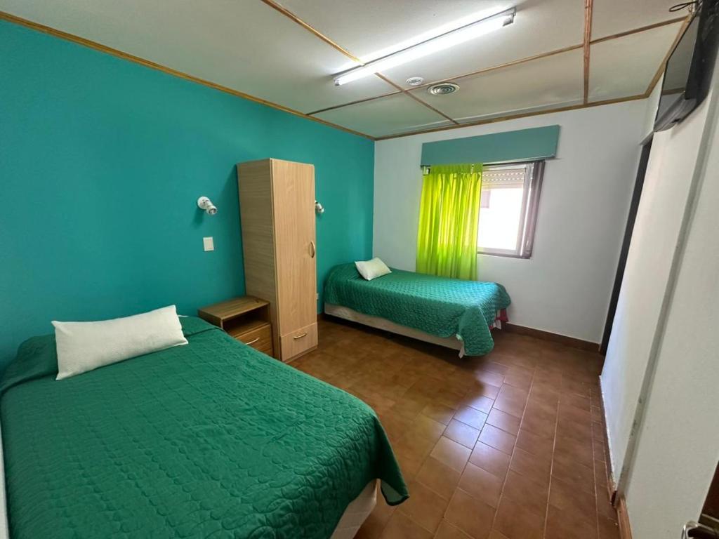 Кровать или кровати в номере Hotel Los Antiguos