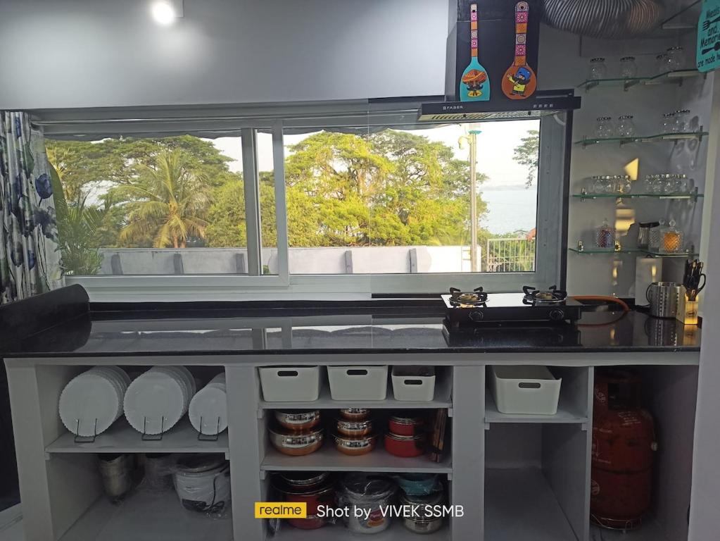 a kitchen with a sink and a counter top at Gangi Kota Penthouse in Kovvūr