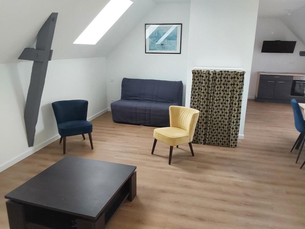 a living room with a couch and chairs and a table at Aux Cormulets in La Baconnière