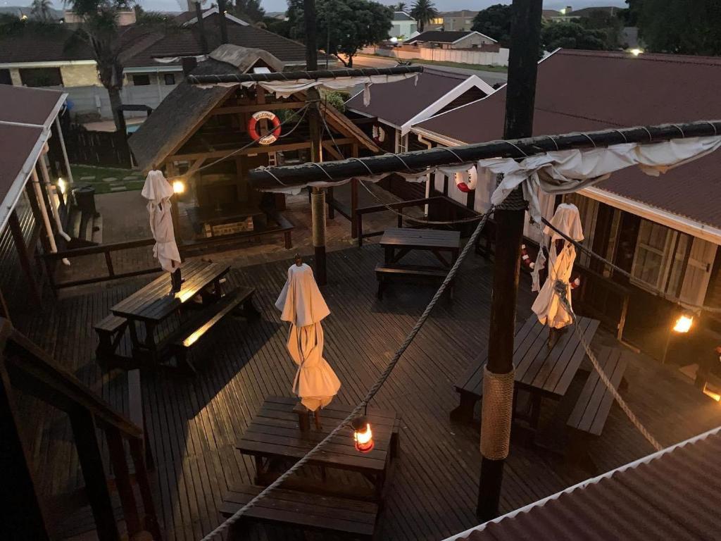 an overhead view of a deck with umbrellas and lights at Bay Cove Inn in Jeffreys Bay
