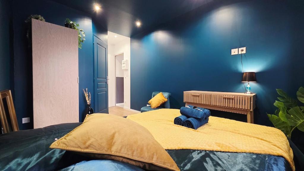a bedroom with blue walls and a large bed at Suite Indigo - Centre Ville in Dunkerque