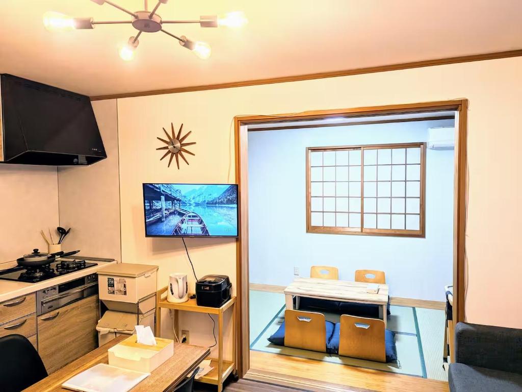 a kitchen with a door open to a kitchen with a stove at Wood River House 門前仲町駅 木場駅 in Tokyo