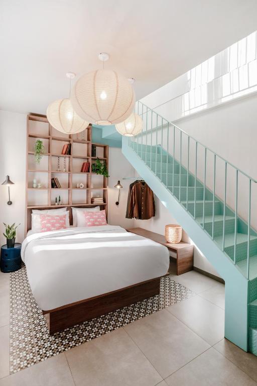 a bedroom with a bed and a staircase at Next door Athens in Athens