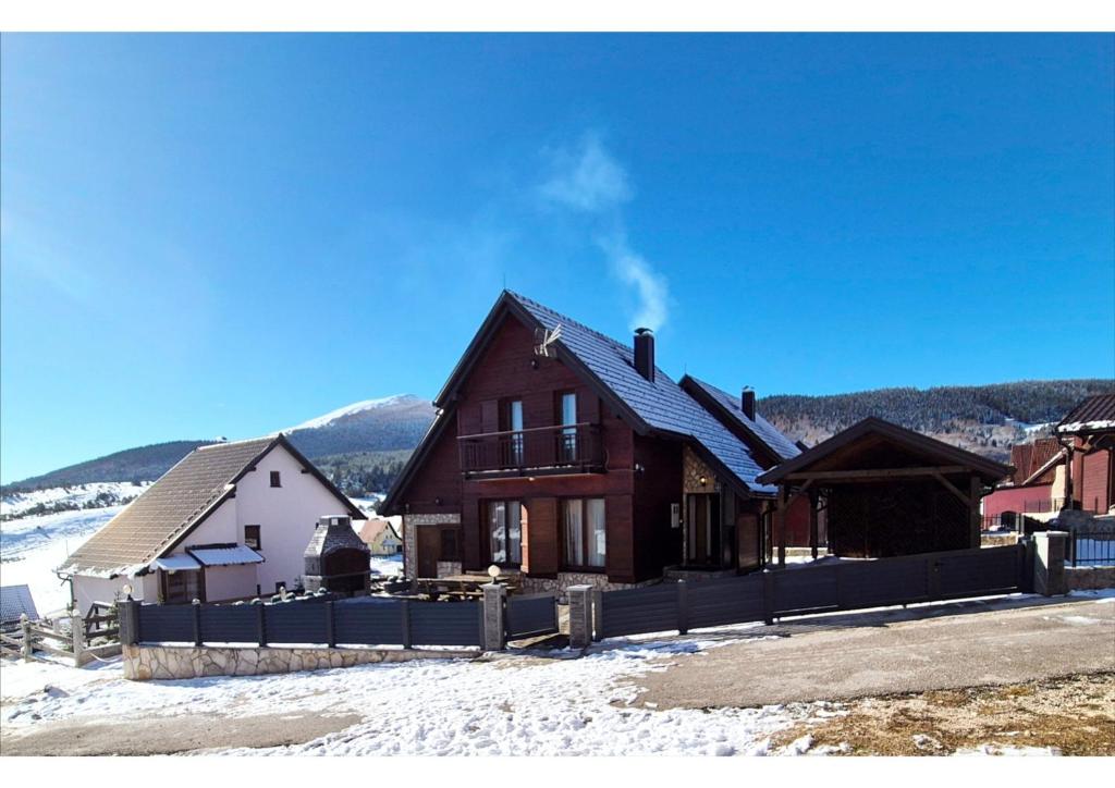 a house in the snow with a fence at Holiday home Maša - Kupres in Kupres