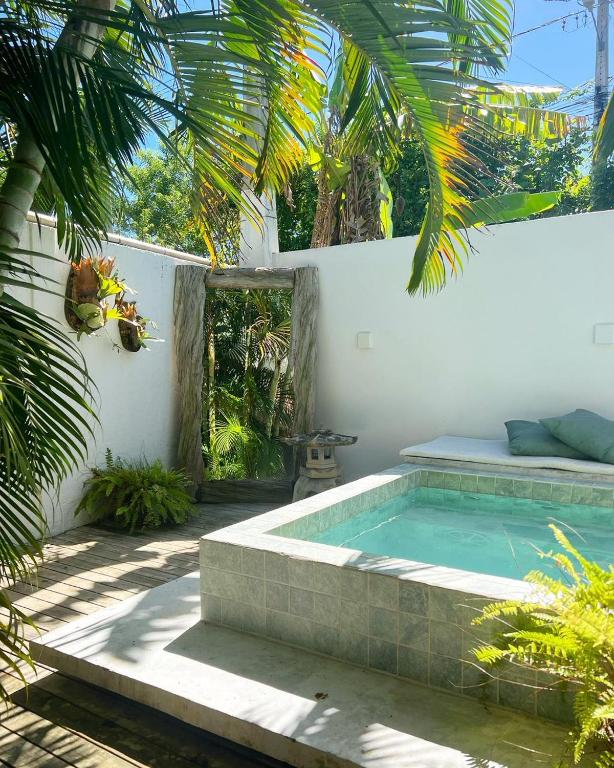 a swimming pool in the backyard of a house at Pousada Vila Piola in Guarda do Embaú