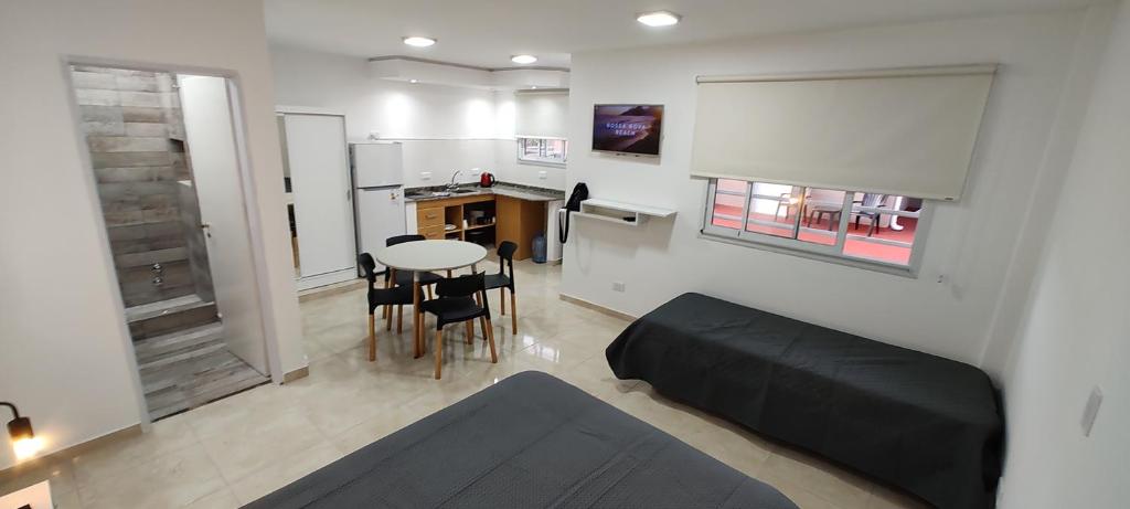 a living room with a bed and a table and chairs at Calle 3 1526 in Santa Teresita