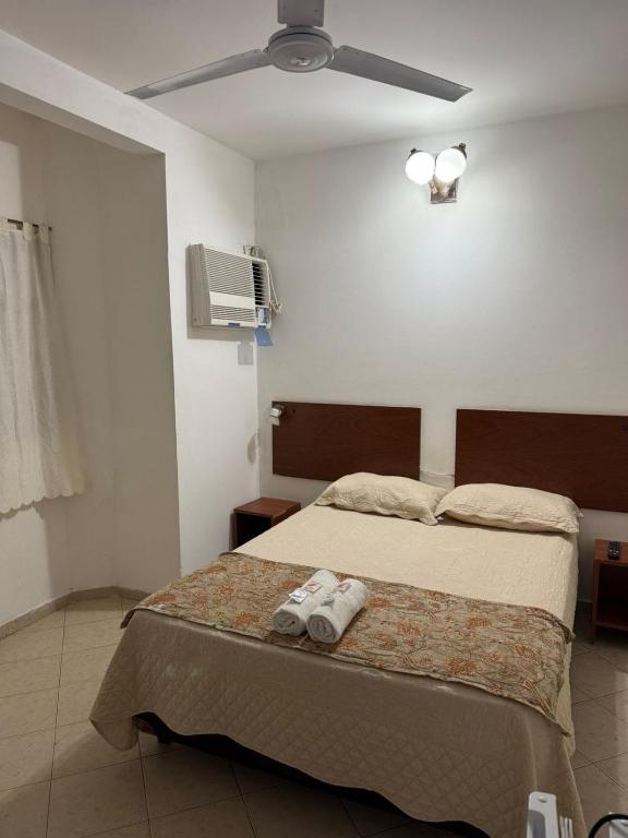 a bedroom with a bed with two towels on it at HOTEL REGINA Formosa in Formosa