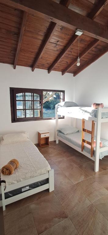 a bedroom with two bunk beds and a wooden ceiling at Pax Costa del Este in Costa del Este