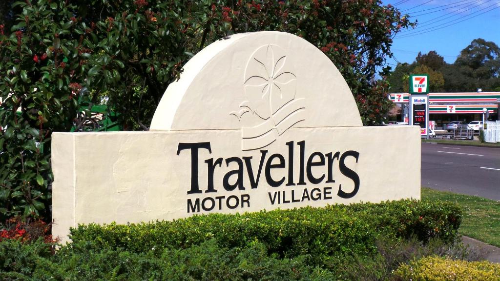 a sign for a travelers motor vehicle dealership at Travellers Motor Village in Newcastle