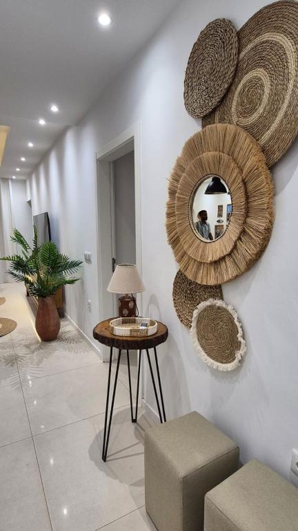 a room with a table and a mirror on the wall at kriola Breeze in Praia