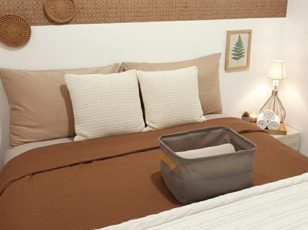 a bedroom with a bed with a suitcase on it at Ortigas Business District Prime Accommodations in Manila