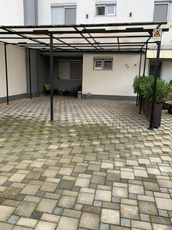 an empty parking lot with a pavilion in front of a building at Aura in Kumanovo