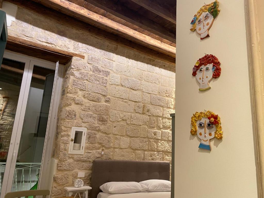 a room with two masks on the wall at DaDa' Home in Trani