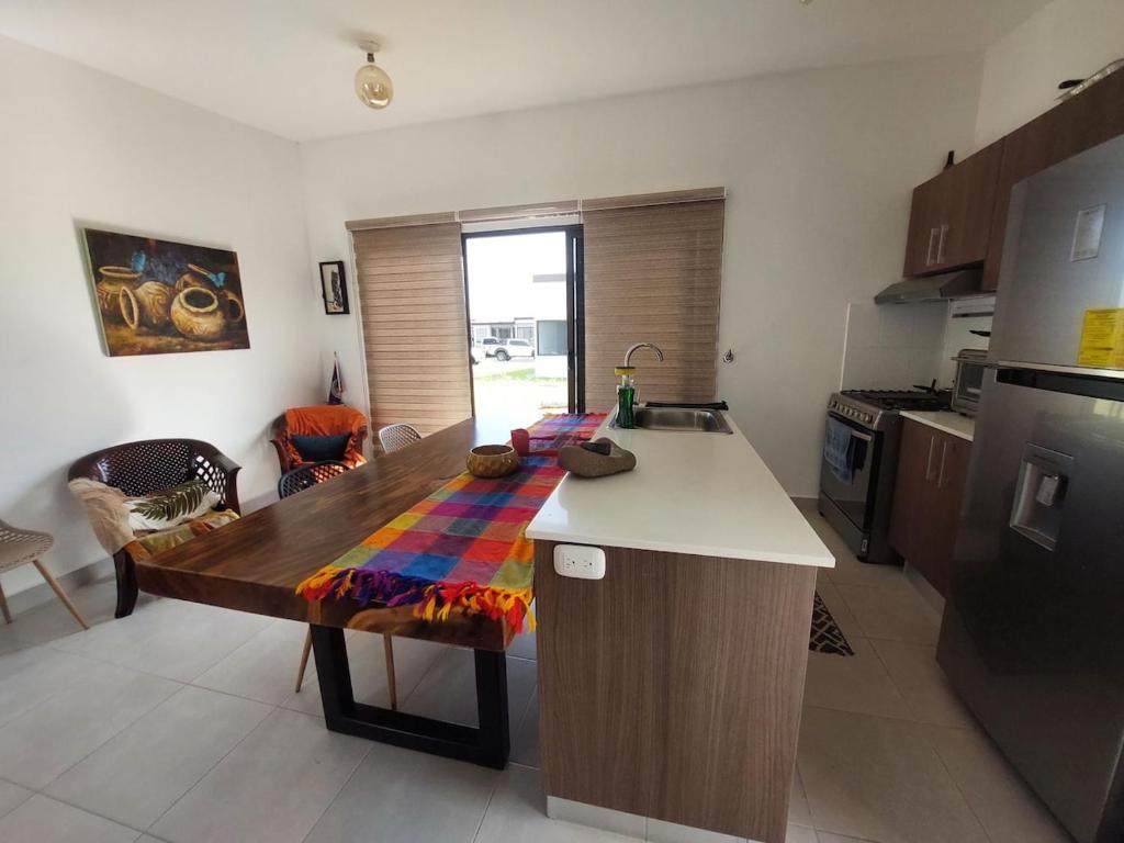a kitchen with a wooden table in a kitchen at Río Hato in El Chirú