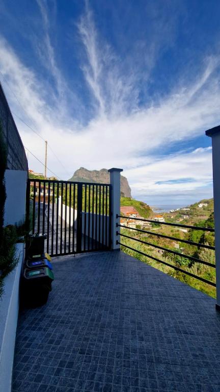 a balcony with a fence and a view of the ocean at Stay Lombinho in Porto da Cruz