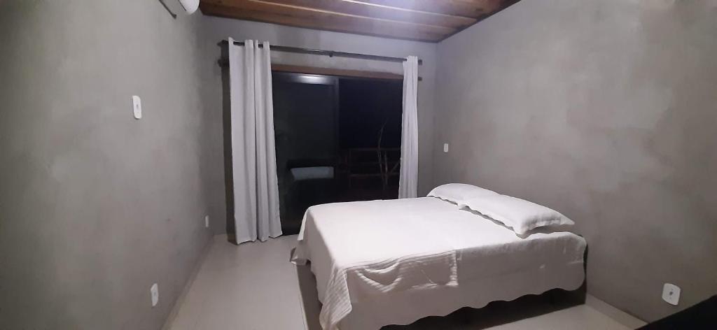 una piccola camera da letto con un letto e una finestra di Refúgio Sereno a Bonito