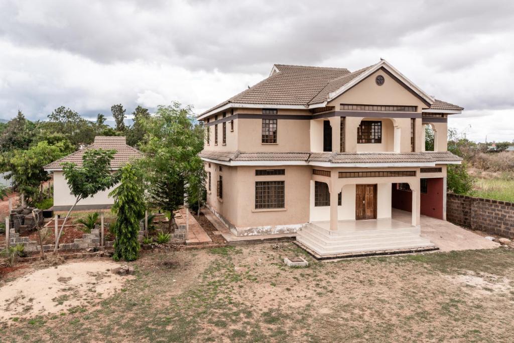 a house that is sitting on top of a yard at Ngelenyi Homes in Voi