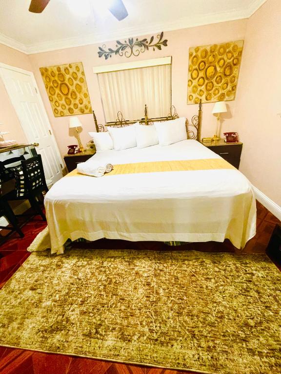a bedroom with a large bed and a rug at Cozy home in Pompano Beach
