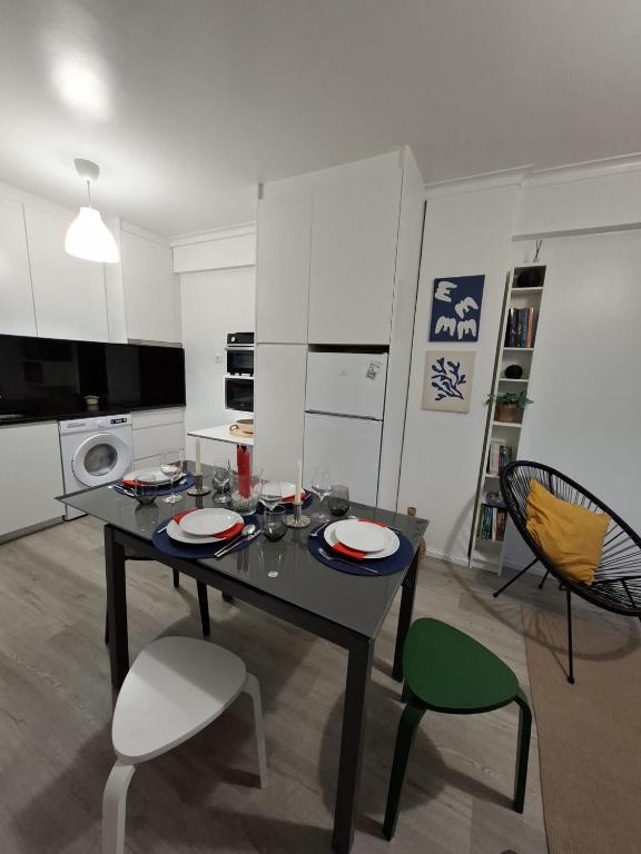 a kitchen with a table and chairs in a room at Afife Beach Apartment in Afife