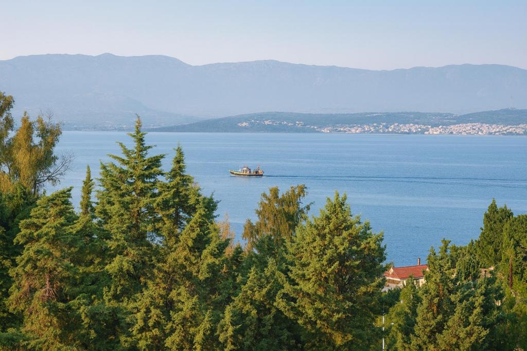 a boat in the middle of a large body of water at Caecilia & Lawrence Villa in Chalkida