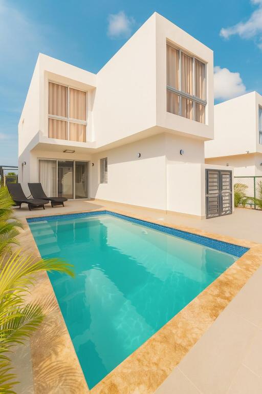 a house with a swimming pool in front of it at Casa Luma Vistacana in Pueblo Bavaro