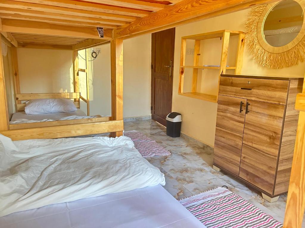 a bedroom with two bunk beds and a mirror at Talia Surf Morocco in Taghazout