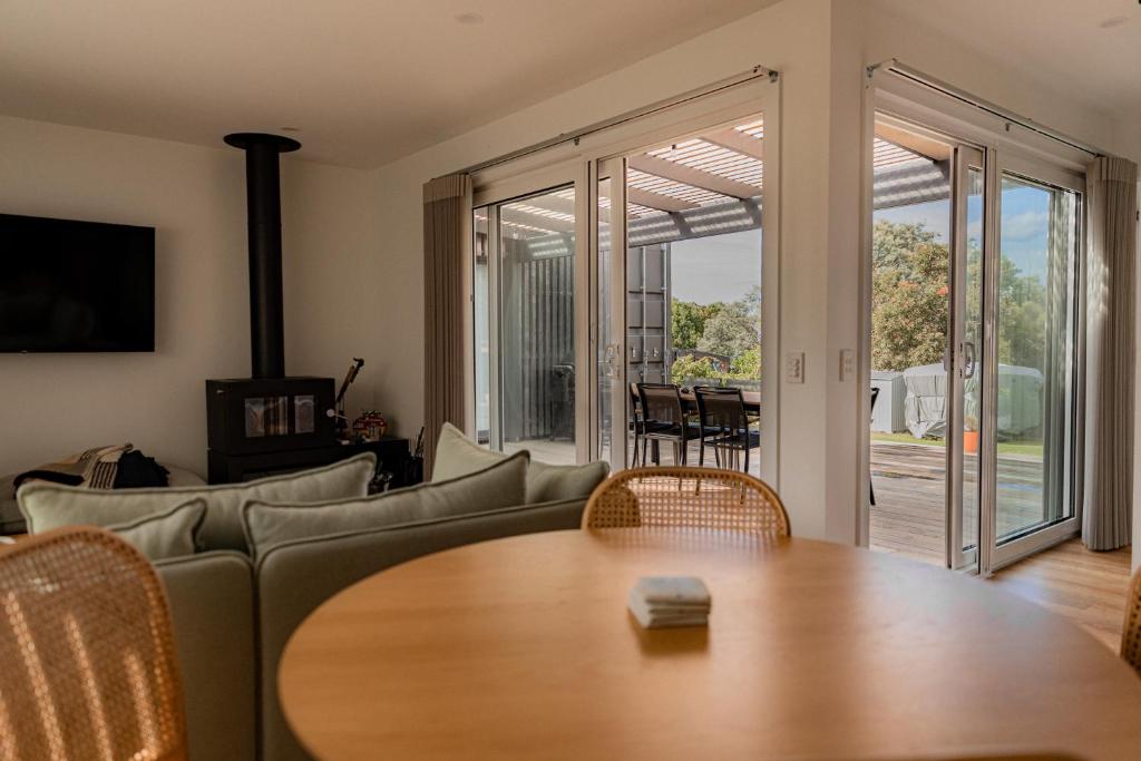 a living room with a couch and a table at Gull's Whisper - all you need in Falmouth