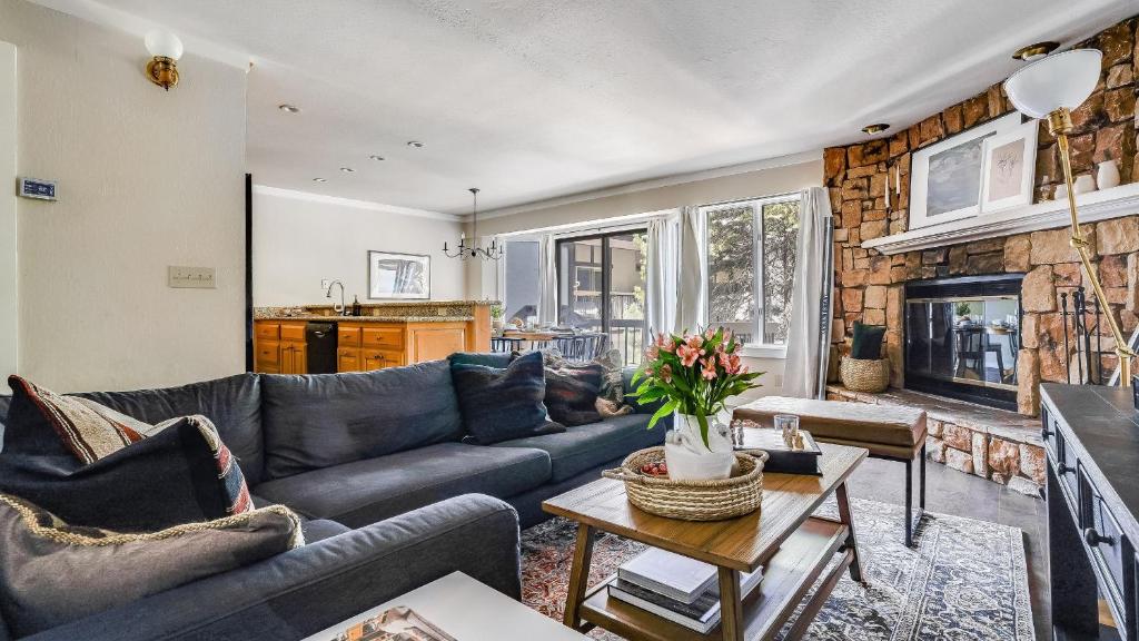 a living room with a couch and a fireplace at Marillac by AvantStay Gorgeous Ski Cabin w Balcony Patio in Olympic Valley