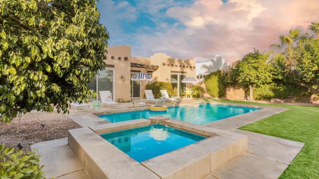 a swimming pool in the backyard of a house at Pool Hot Tub Yard Games Chic Midcentury Design Painted Sand by AvantStay in Bermuda Dunes