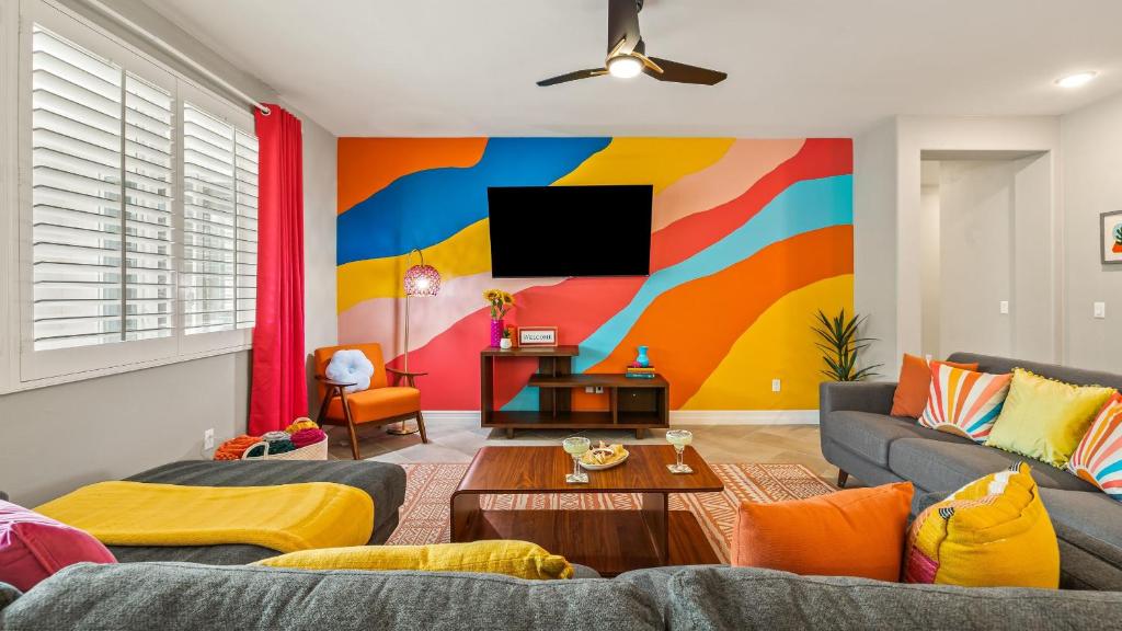 a living room with a colorful wall at Kaleidoscope by AvantStay Colorful Escape Pool in Indio