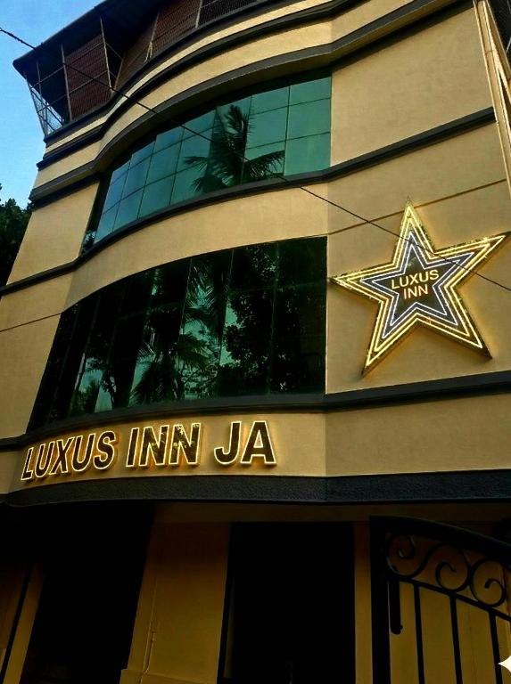 a building with a star on the side of it at LUXUS INN JA Star in Chacka