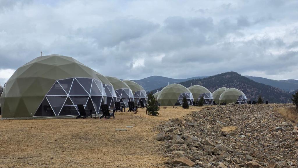 a group of domes with people standing in front of them at The Nest at Black Hawk in Black Hawk