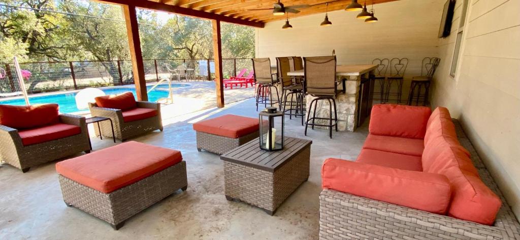 a patio with couches and chairs and a table at Casa Floerke in Concan