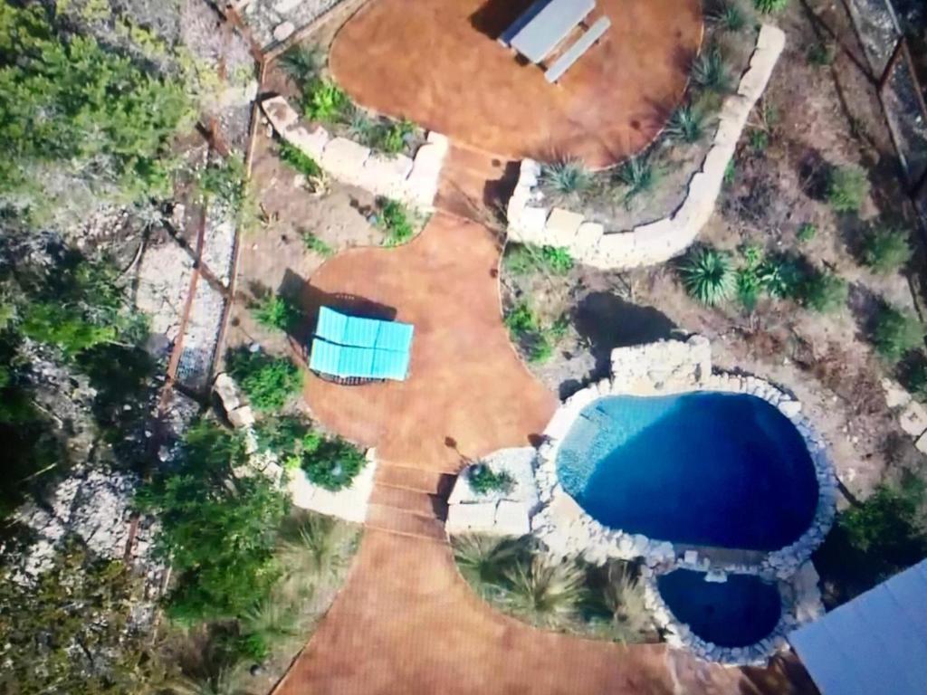 an aerial view of a swimming pool in a yard at Kickin Back in Concan