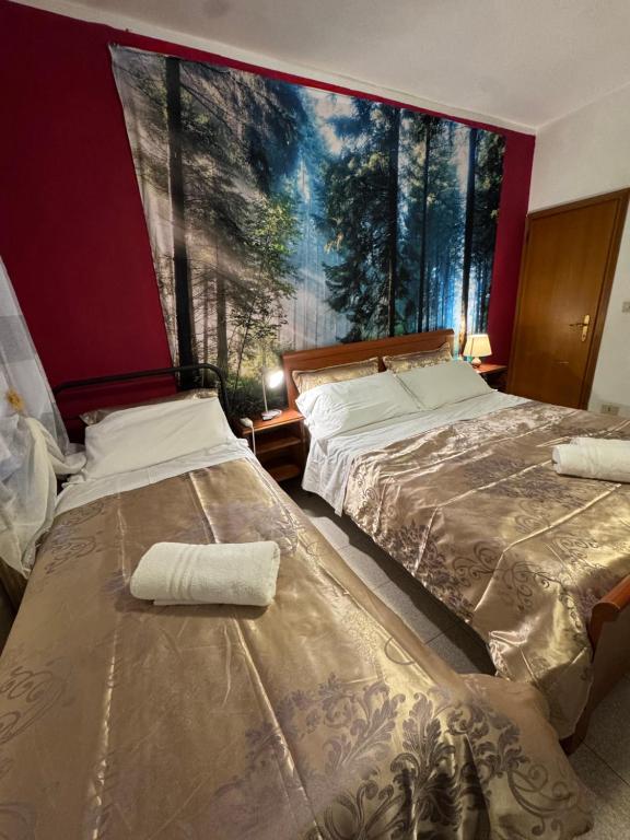 two beds in a room with a large window at Admiral Home Venice Center in Venice