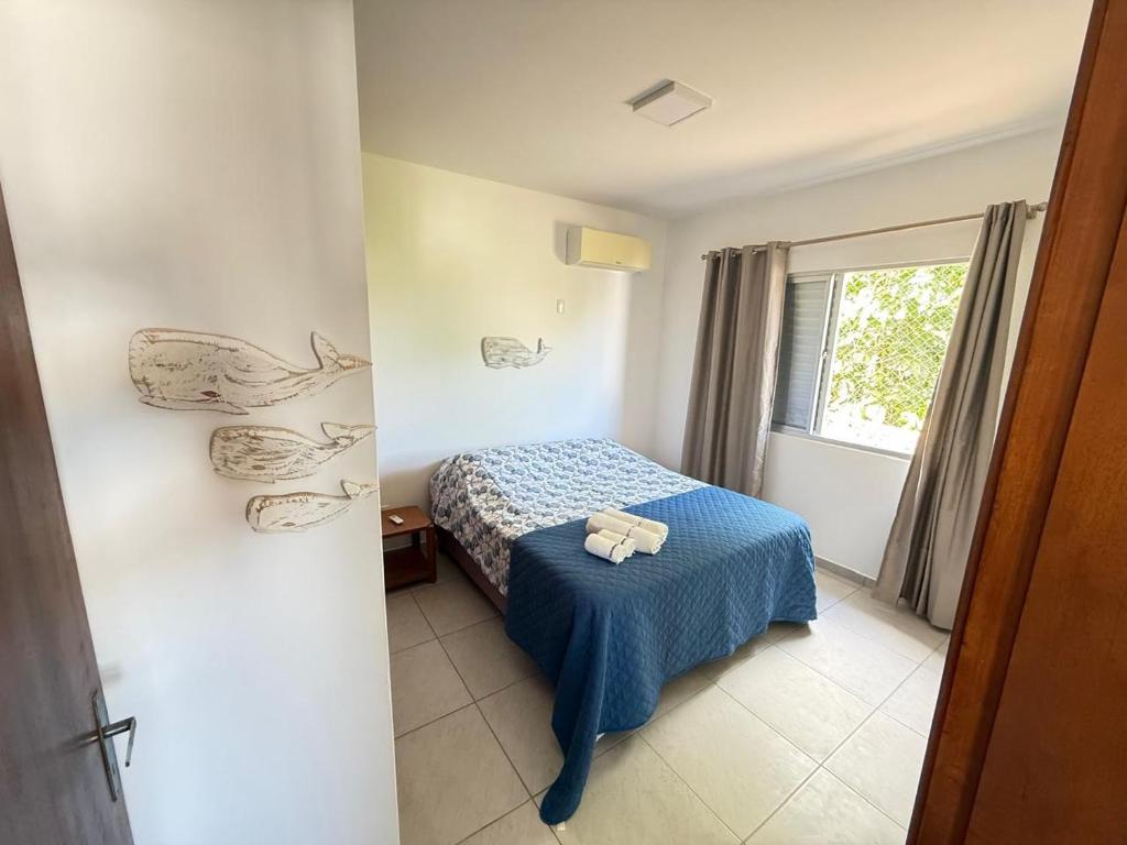 Una cama o camas en una habitación de Residencial Mansur - Jurerê