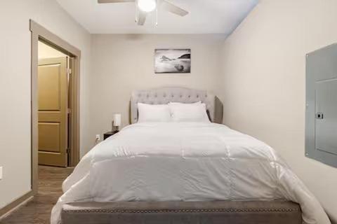a white bedroom with a large bed in it at Queen City Getaway with Pool in Charlotte