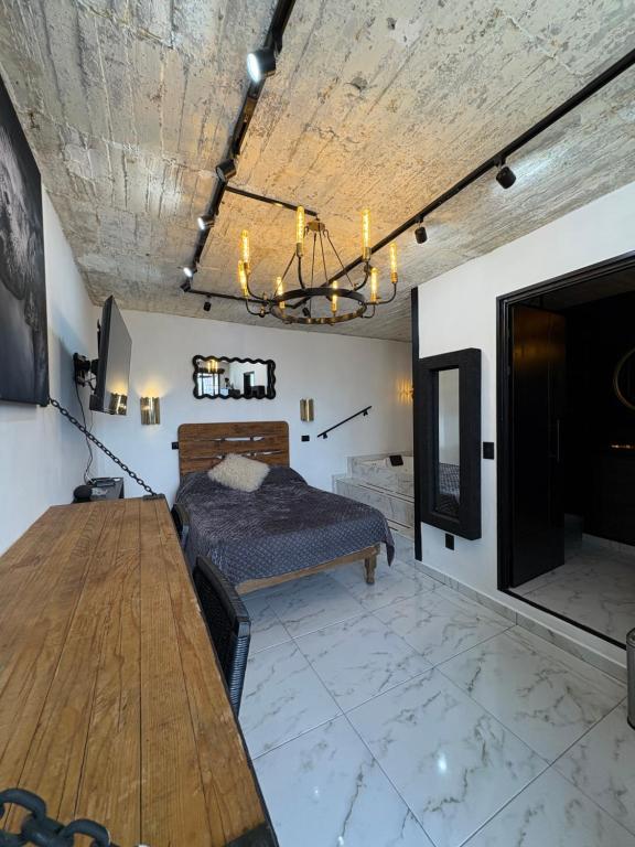 una camera da letto con un letto e un tavolo di legno di Secrect Jacuzzi Studio a San Miguel de Allende