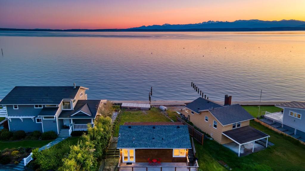 an aerial view of houses on the water at sunset at Cozy Whidbey Island Stay Steps to the beach Fireplace BBQ Near Trails in Freeland