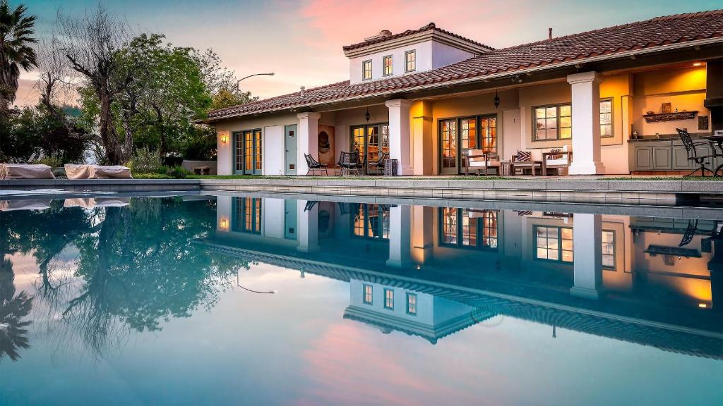 a house with a swimming pool in front of it at Wellsona Vineyard Retreat Pool Hot Tub Views Main Home Guest Home in Paso Robles