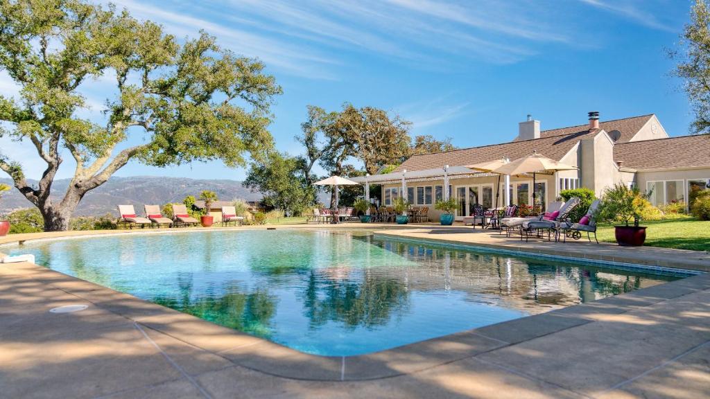 a swimming pool in front of a house at Sonoma Sunshine by AvantStay Countryside Views in Glen Ellen