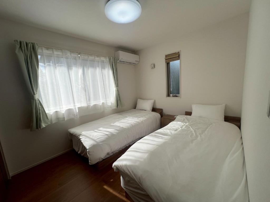 Postel nebo postele na pokoji v ubytování Mukae House