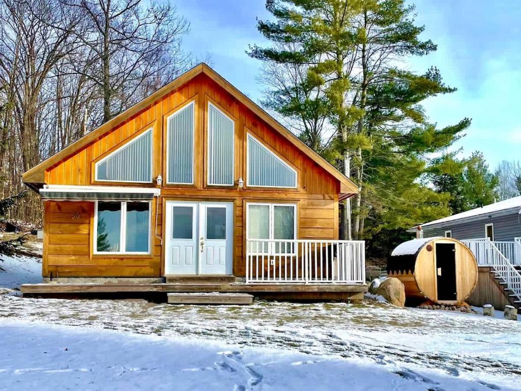 a small log cabin in the snow at #90 Lakefront 3-bdrm Chalet in Muskoka in Port Carling