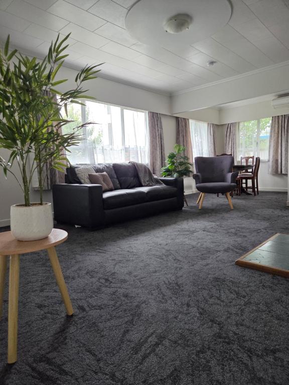 a living room with a couch and a table at Accessible Respite House in Whangarei
