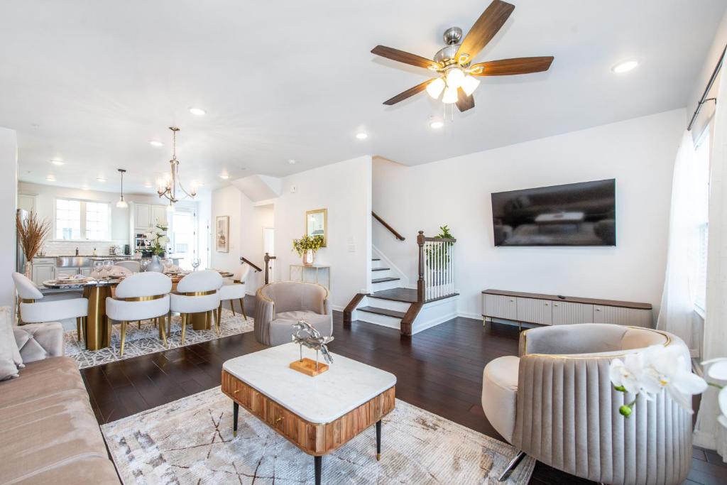 a living room and dining room with a ceiling fan at Glam Family Funhouse NYC Access Adventure in Fair Lawn
