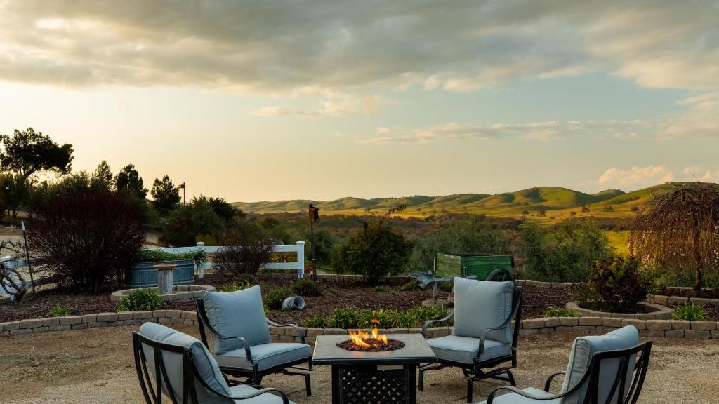 a patio with chairs and a table and a fire pit at Olive Ranch by AvantStay Enjoy Sunsets over the Valley 4.5 Acre Ranch Home in Paso Robles